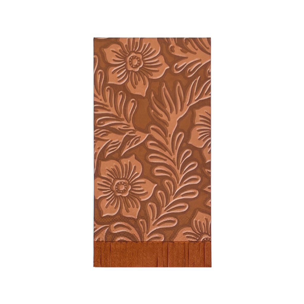 Light brown floral tooled leather print on a rectangle, brown, paper dinner napkin with brown fringe cut on the bottom 