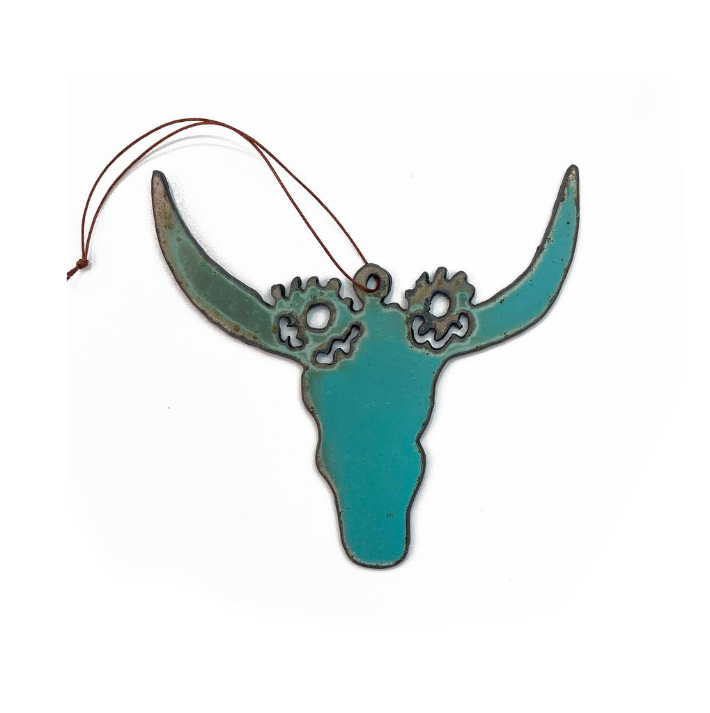 Turquoise longhorn skull shaped iron ornament. Brown string attached for hanging.