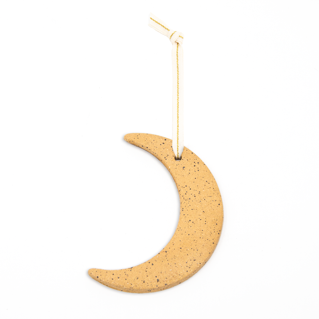 tan speckled crescent moon ornament. creme colored ribbon with a gold stripe.