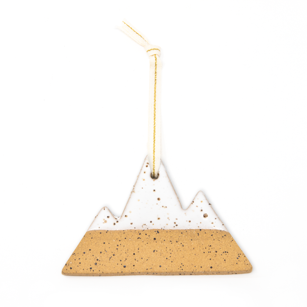 White and sand colored speckled mountain ceramic ornament. Creme colored ribbon with a gold stripe for hanging.