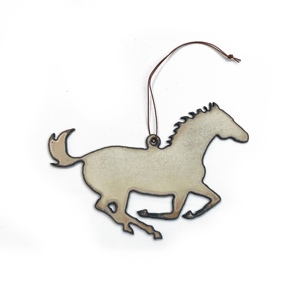 White iron horse shaped ornament with a brown string for hanging.