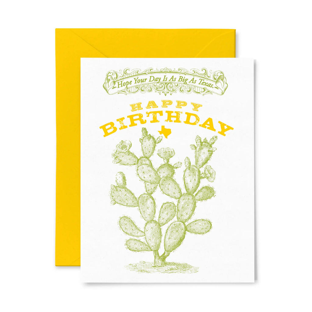 White greeting card with green banner and text saying "Hope your day is as big as Texas." Below the banner are words Happy Birthday with small state of Texas in bright yellow. Underneath the yellow is a green drawing of cactus. Behind the greeting card is a marigold paper envelope. 