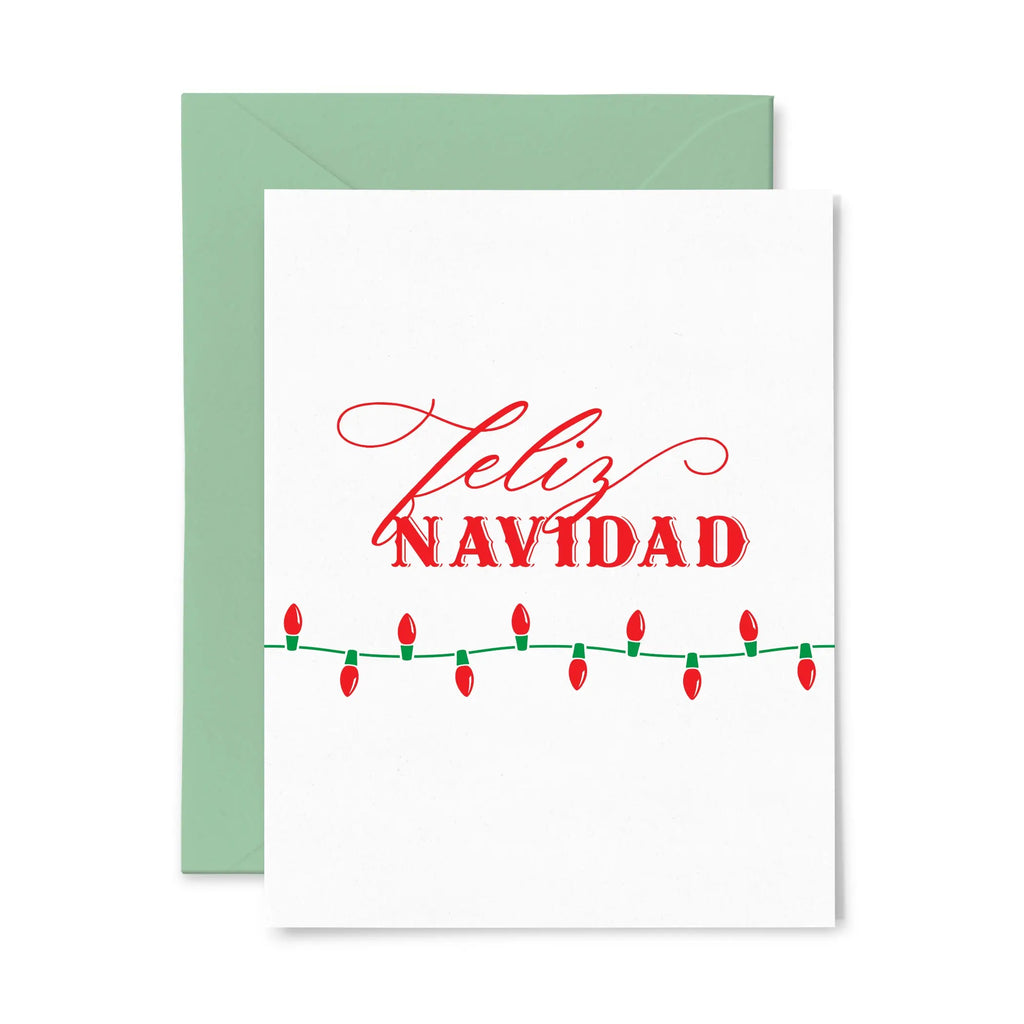 White "Feliz Navidad" card with a green strand of red lights.