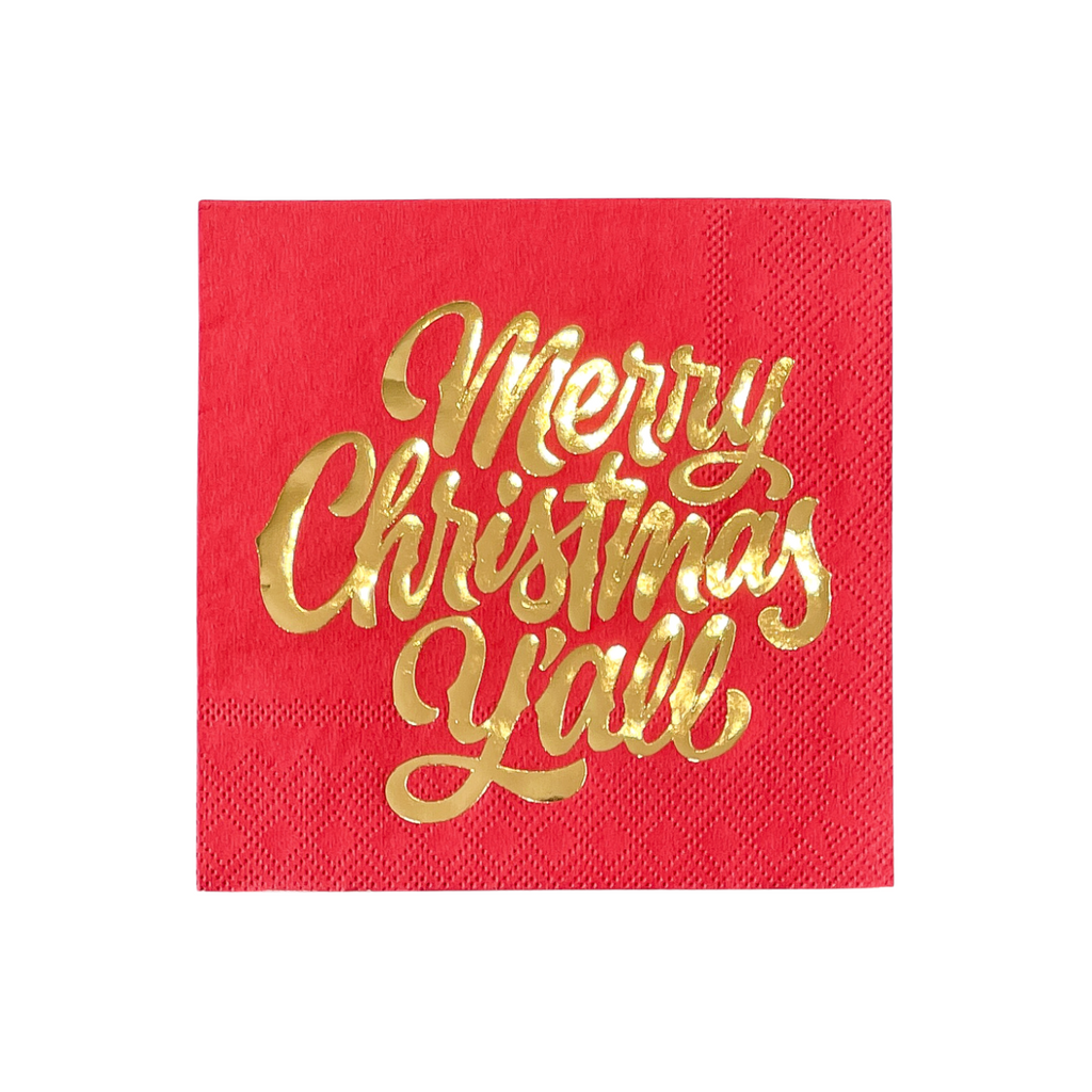 Red, paper cocktail napkin with gold foil text saying "Merry Christmas Y'all"