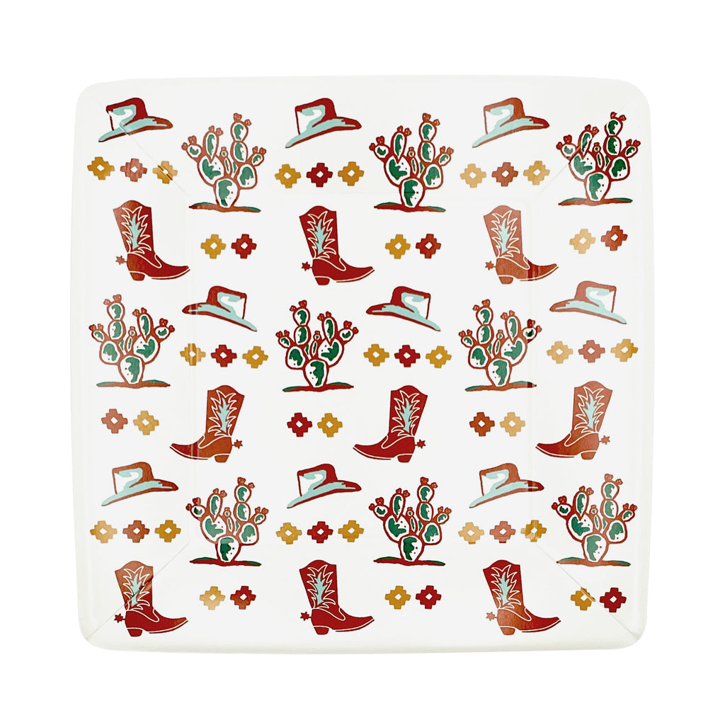 White square dinner plates with a gold and burnt orange concho, cowboy hat, cowboy boot, and cactus print.