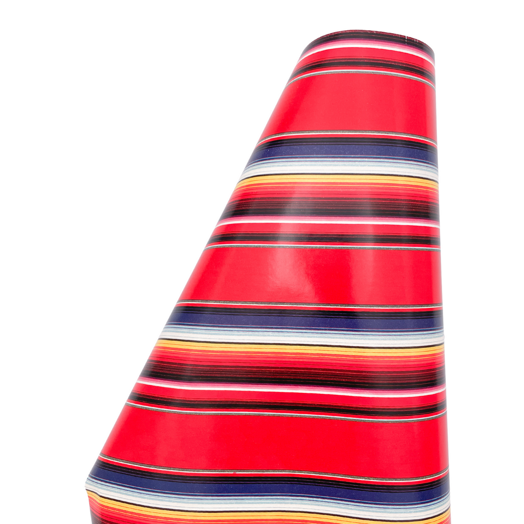 Heavyweight gift wrap roll with red serape print. Colors are blue, red, yellow, white stripes.
