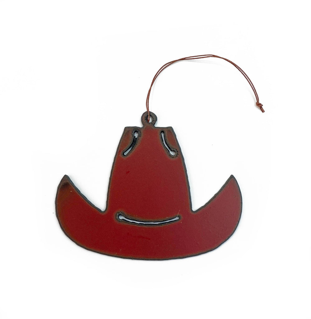 Red iron cowboy hat ornament with a small string attached to hang on a Christmas tree.